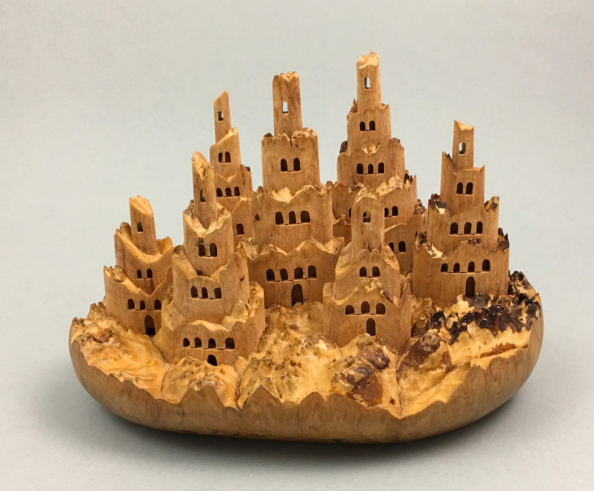 Miniature Castles Emerge from Burled Wood in Carved Kinetic