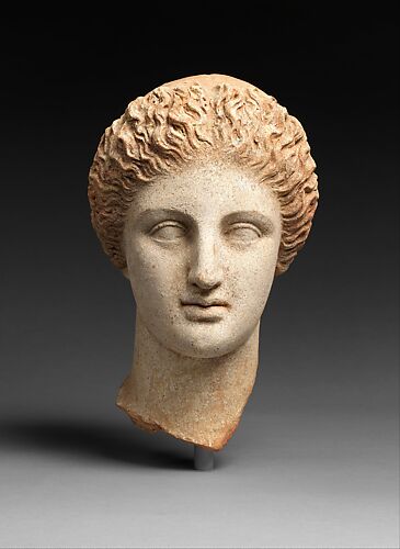 Terracotta head of a woman, probably a sphinx - Greek - Archaic