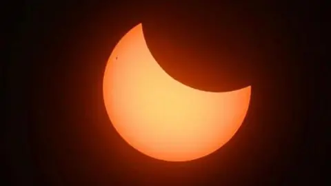 Partial solar eclipse captured across the south of England