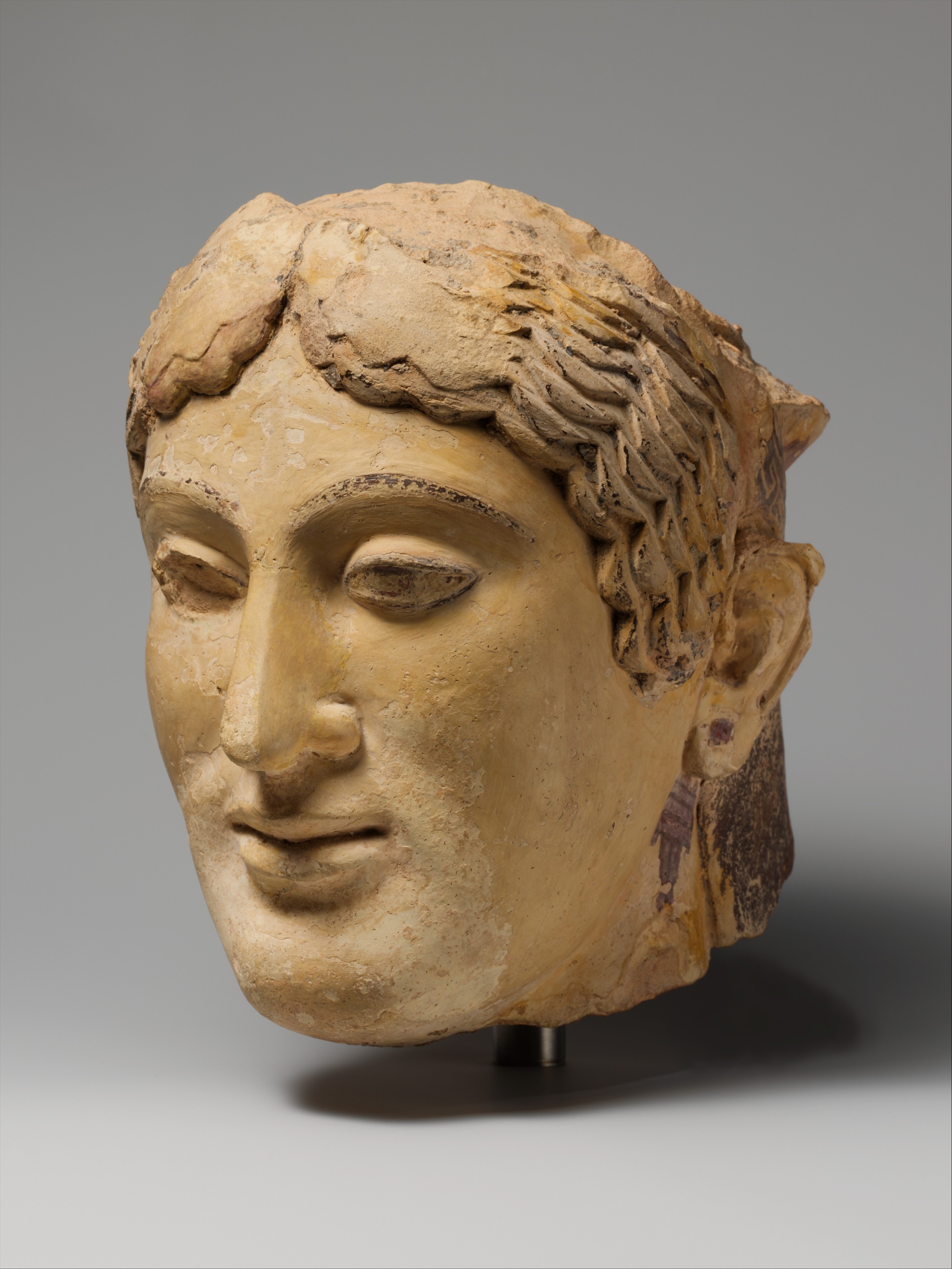 Terracotta head of a woman, probably a sphinx - Greek - Archaic
